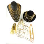 A large selection of gold plated and yellow metal neck chains, etc, some with curb links, some box