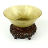 Chinese hardstone olive bowl, raised on carved hardwood stand, 10.5cm h