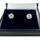 Pair of solitaire diamond ear studs, in claw settings stamped 14k