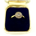 Diamond dress ring, the central stone set within a hoop of smaller stones, on a yellow metal band