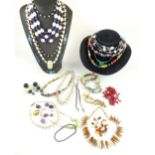 Costume jewellery comprising carved stone Egyptian items, amber beads, Murano beads, carved