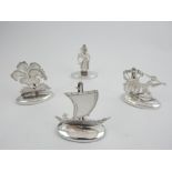 Set of four Eastern themed sterling silver menu holders.