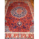 Tabriz red ground carpet, of traditional floral design, with central lobed medallion, fringed,