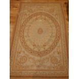 Aubusson style tapestry, oval medallion to centre, overall of floral design on pale beige border,