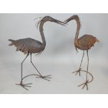 Pair of aged metal garden ornaments modelled as cranes, 110cm h.