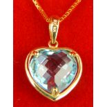 9ct yellow gold faceted blue topaz heart shaped pendant on chain.