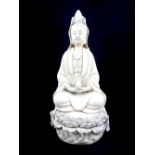 Chinese blanc de chine figure, study of Guan Yin holding a vase seated on giant lily pad,
