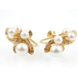 Pair of 14ct gold pearl cluster earrings arranged around a foliate motif, screwback mechanism.