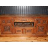 Late Victorian carved walnut sideboard with frieze drawer over open compartment and cupboard