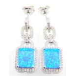 A pair of silver and cubic zirconia drop earrings set with a rectangular shaped blue opalite stone.