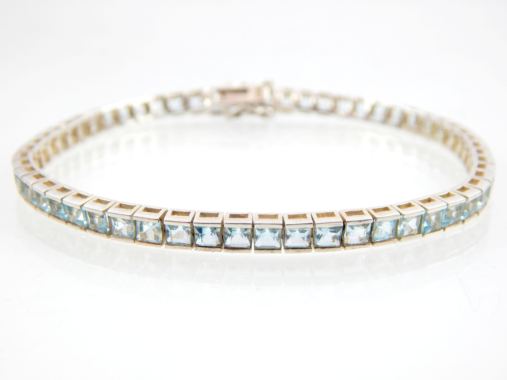 Aquamarine line bracelet, 57 princess cut stones set in sterling silver. - Image 2 of 2