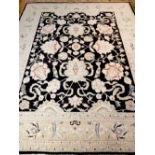 Large Ziegler style carpet, the centre floral design over indigo ground,