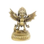 Cast bronze figure of Garuda, holding a snake and standing on a woman,