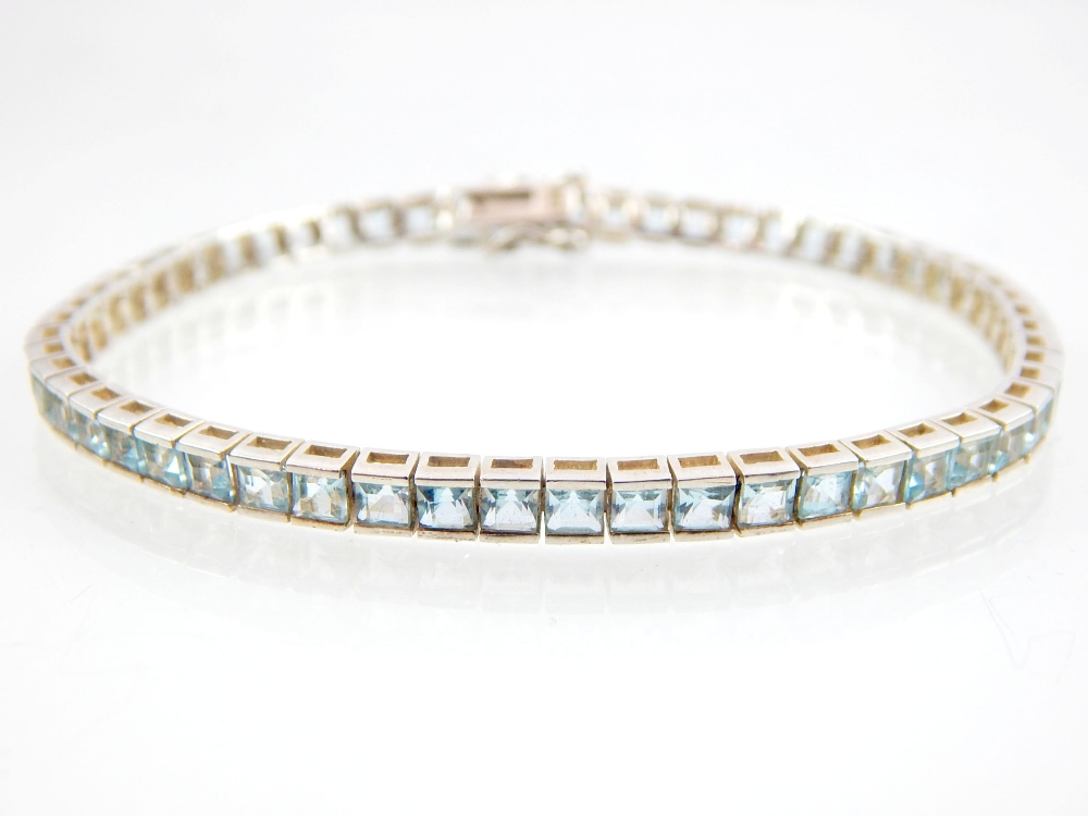 Aquamarine line bracelet, 57 princess cut stones set in sterling silver.