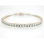 Aquamarine line bracelet, 57 princess cut stones set in sterling silver.