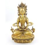 Cast brass figure of Amiayus, seated and holding a casket,