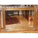 Gilded French style mirror, floral corners, bead trim, bevelled glass, 75 x 107 cm.