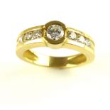 Diamond dress ring, the central collet set stone flanked by six further stones,