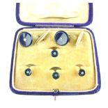 Boxed set of diamond set shirt studs and cufflinks, the stones set within blue disks,