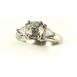 Diamond three stone ring, the central claw set stone flanked by trillion cuts,