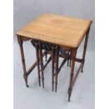 Nest of three mahogany tables, turned column legs and bar stretchers, brass castors,