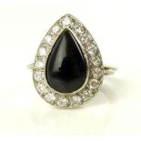 Pear shaped onyx dress ring set within a diamond band, on a white gold hoop marked 18ct, 7.
