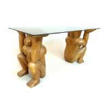 Carved wooden 'monkey' supports smoke glass coffee table top 91cm w, monkey 44.