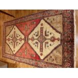 Persian red and honey ground rug, two pole medallion to centre with stepped borders over