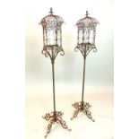 A pair of metal garden cage lanterns on scroll legs, approx 135cm H. (2)