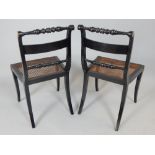 Pair of Regency gilt metal mounted ebonised dining chairs with turned top rails and spars and cane