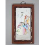 An early 20th century Chinese porcelain panel in a wooden frame, depicting a mythical scene of