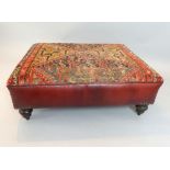 Red leather stool, kelim top, raised on four turned wooden feet, 73cm w, 97cm l, 36cm h