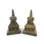 Pair of bronze obelisks, of square stepped form and incorporating panels showing exotic creatures,