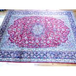 Large Persian red ground Nafjabad carpet, star medallion to centre over floral design within