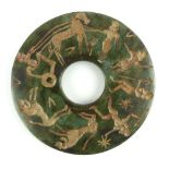 Hardstone disk pendant, carved with warrior figures, 8cm