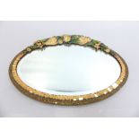 Early 20th C barbolla oval easel mirror with moulded gesso floral decoration and bevelled glass,