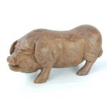 Carved hardwood pig, possibly palmwood,