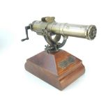 20th century model of a Gatling gun, raised on a beech base,