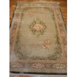 Chinese silk rug, green ground, key borders, bird and floral edges and similar panels to centre,