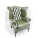 Wingback study chair, green leather buttonback, brass studs,