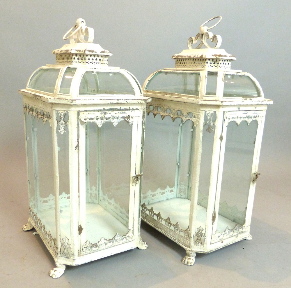 A pair of large French style antiqued garden lanterns, octagonal, glass door, paw feet,