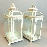 A pair of large French style antiqued garden lanterns, octagonal, glass door, paw feet,