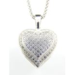 A silver and cubic zirconia heart shaped pendant and chain