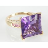Amethyst single stone dress ring, the square cut stone claw set in a 9ct gold band, 6.