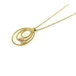 9ct yellow gold 'Happy Feet' circular pendant, suspended on a 9ct yellow gold chain, 3.
