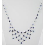 Sapphire necklace set in 14ct white gold, the oval cut stones latticed to form a half diamond,