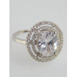 A silver and large oval cubic zirconia double halo ring