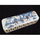 Chinese ceramic desk weight, blue, red and white glaze, study of warriors in a garden,