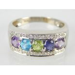 White metal multi-coloured gem set dress ring, the five stones set on a millegrain ground, 5.