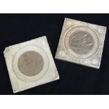 Two square composition plaques inlaid with circular Zodiac medallions, one Scorpio, the other Libra,